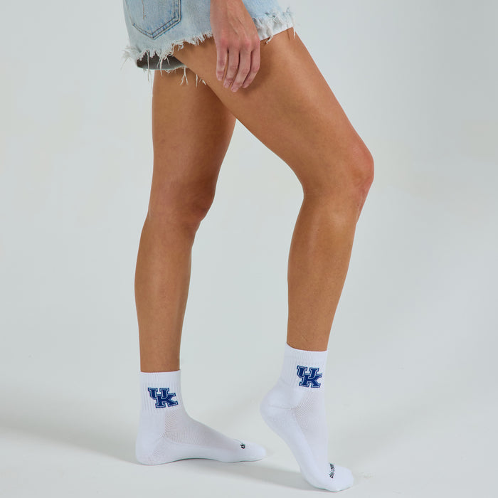 Woman wearing Del Campo Kentucky Wildcats golf socks, studio shot, no shoes