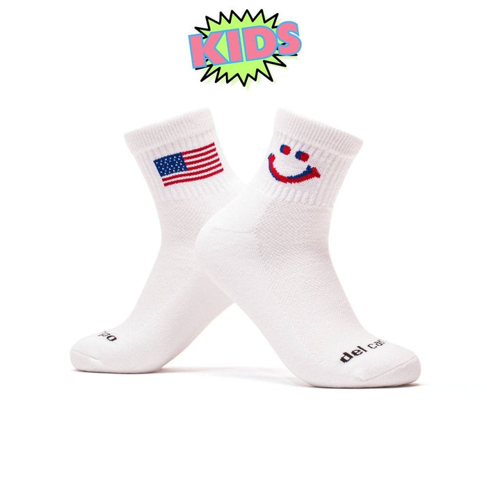 Del Campo Kids Pack golf socks featuring four kids' designs: smiley, blue smiley, pink smiley, and 1776