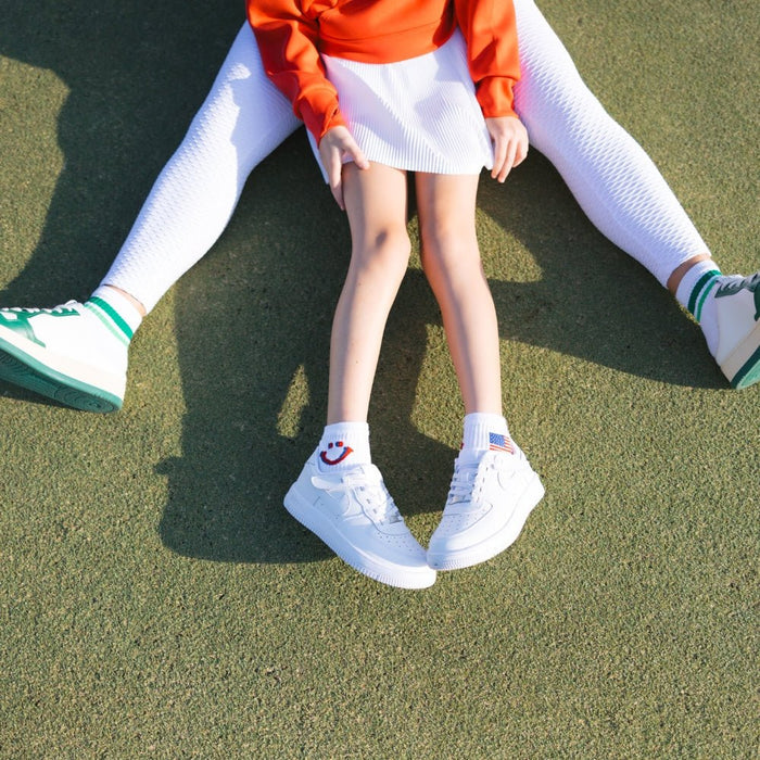 Del Campo Kids Pack golf socks featuring four kids' designs: smiley, blue smiley, pink smiley, and 1776
