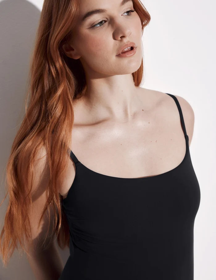| Front view of model wearing the Leakproof Classic One Piece Swimsuit highlighting the neckline, coverage and fit | Black