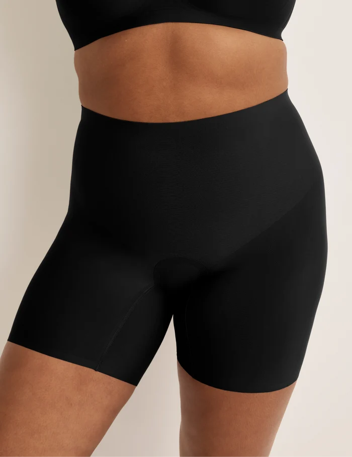 Adiya is wearing KNIX L | Front view of model wearing the Leakproof Contour Thigh Saver® 6”, highlighting the coverage and smooth fit | Black
