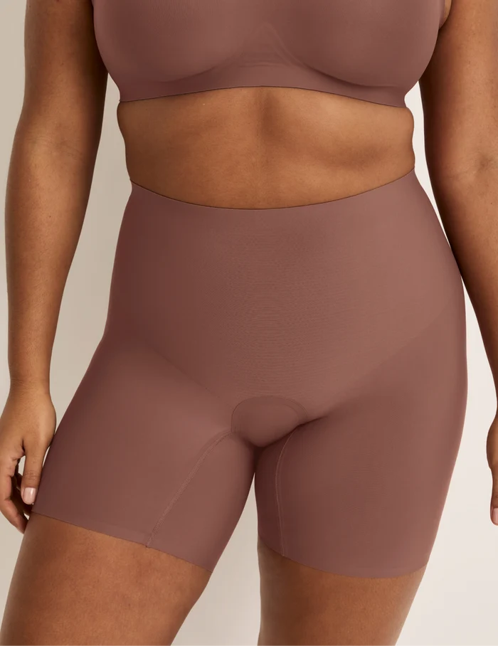 Adiya is wearing KNIX L | Front view of model wearing the Leakproof Contour Thigh Saver® 6”, highlighting the coverage and smooth fit | Sola