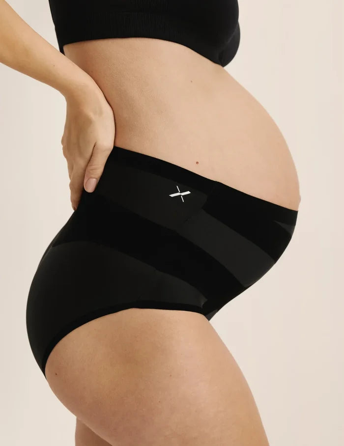 Elyse is wearing KNIX L | Side view of pregnant model wearing the Leakproof CoreLove High Rise, highlighting the coverage and hugging fit | Black