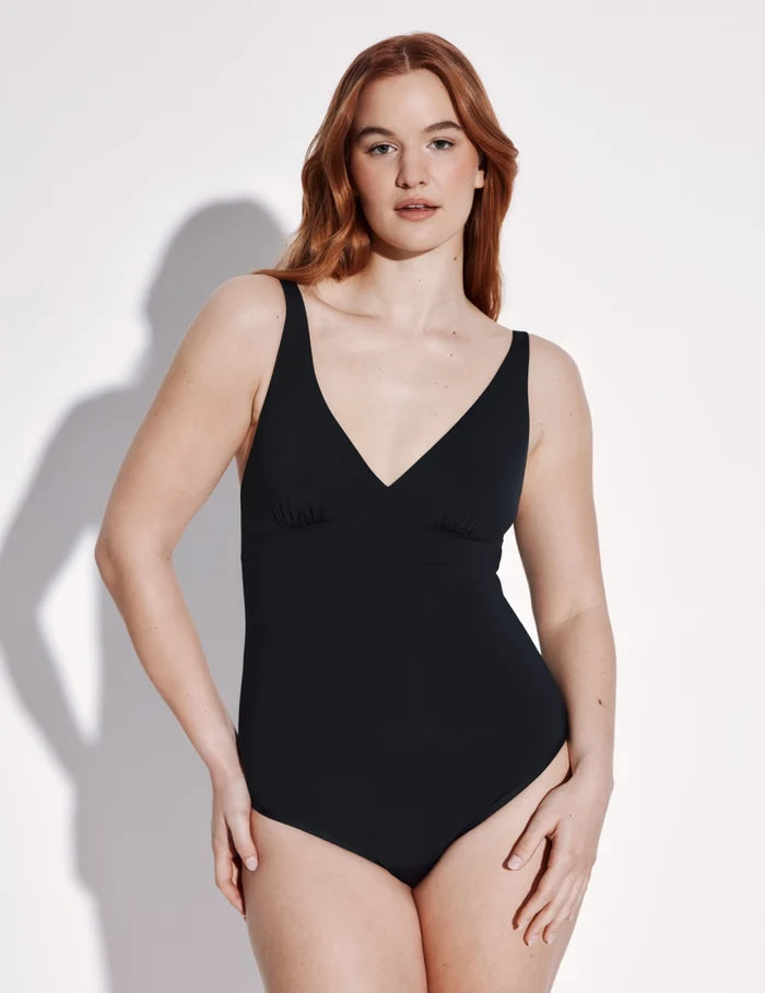 | Front view of model wearing the Leakproof Deep V One Piece Swimsuit highlighting the neckline, coverage and fit | Black