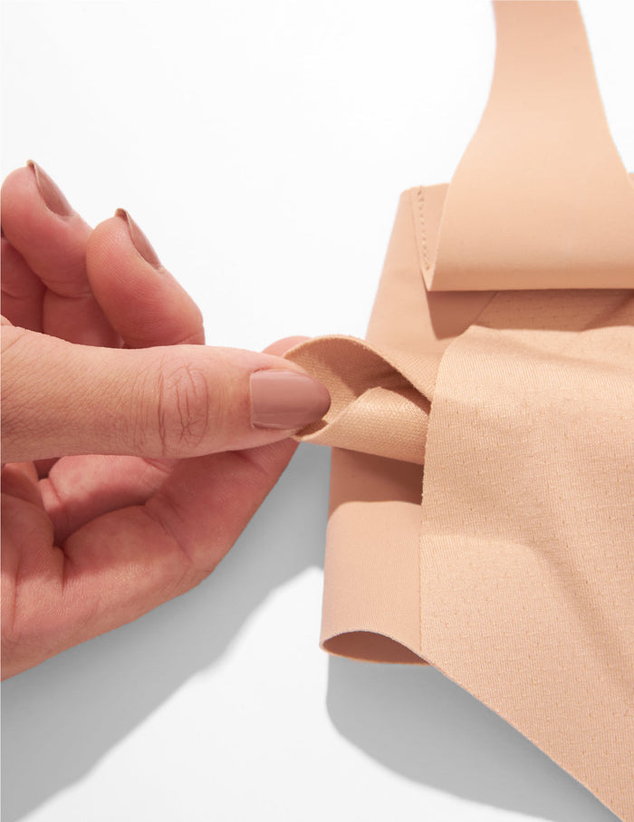 | Leakproof Nursing Pads shown being pulled out of a bra opening | General