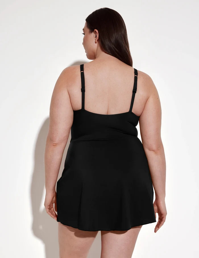 | Back view of model wearing the Leakproof Sculpt Deep V Swim Dress highlighting the coverage and fit | Black