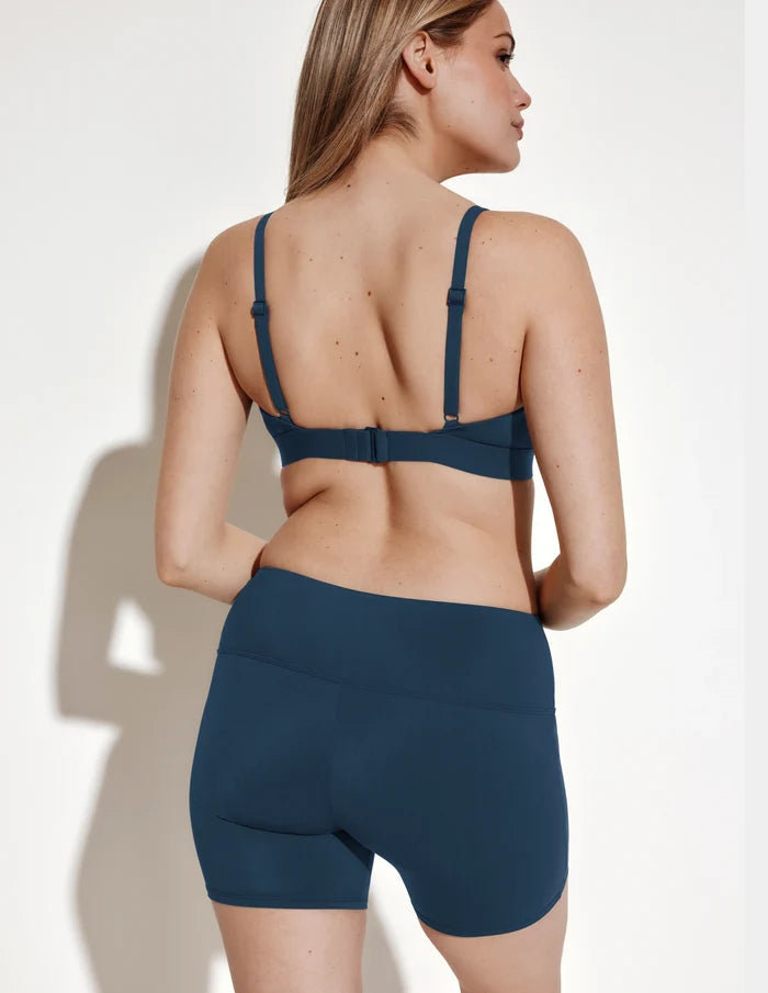 | Back view of model wearing the Leakproof Sculpt Long Swim Short highlighting the coverage and fit | Horizon