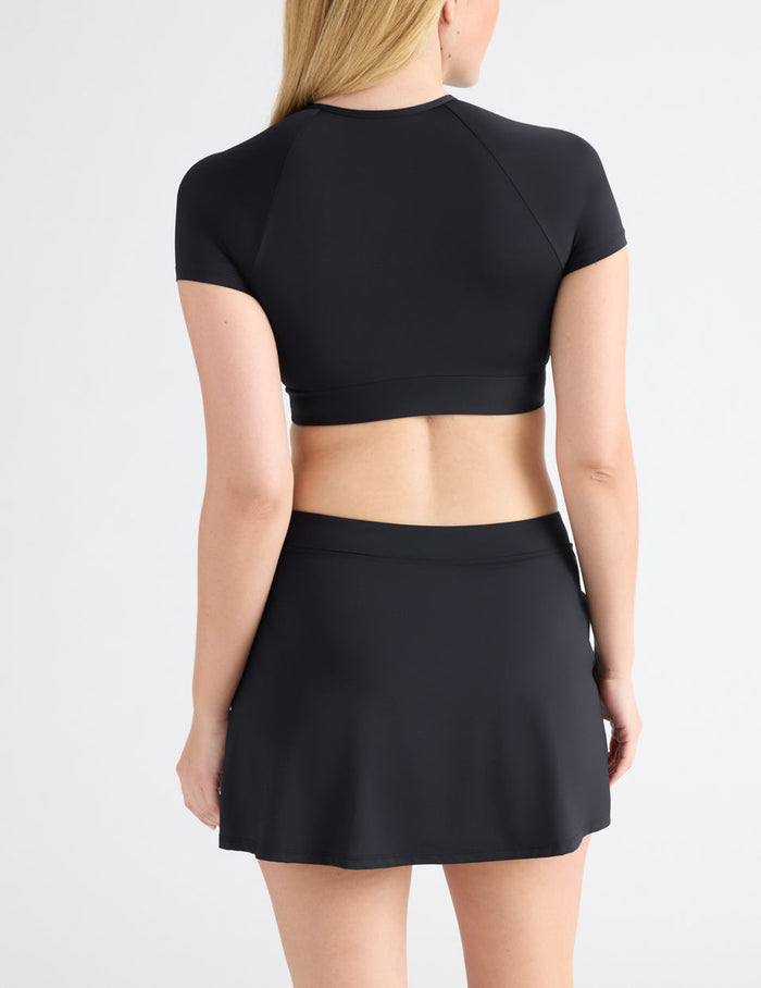 Isabelle has 40" hips and wears a Knix size M | Back view of model wearing the Leakproof Swim Skirt highlighting the coverage and fit | Black