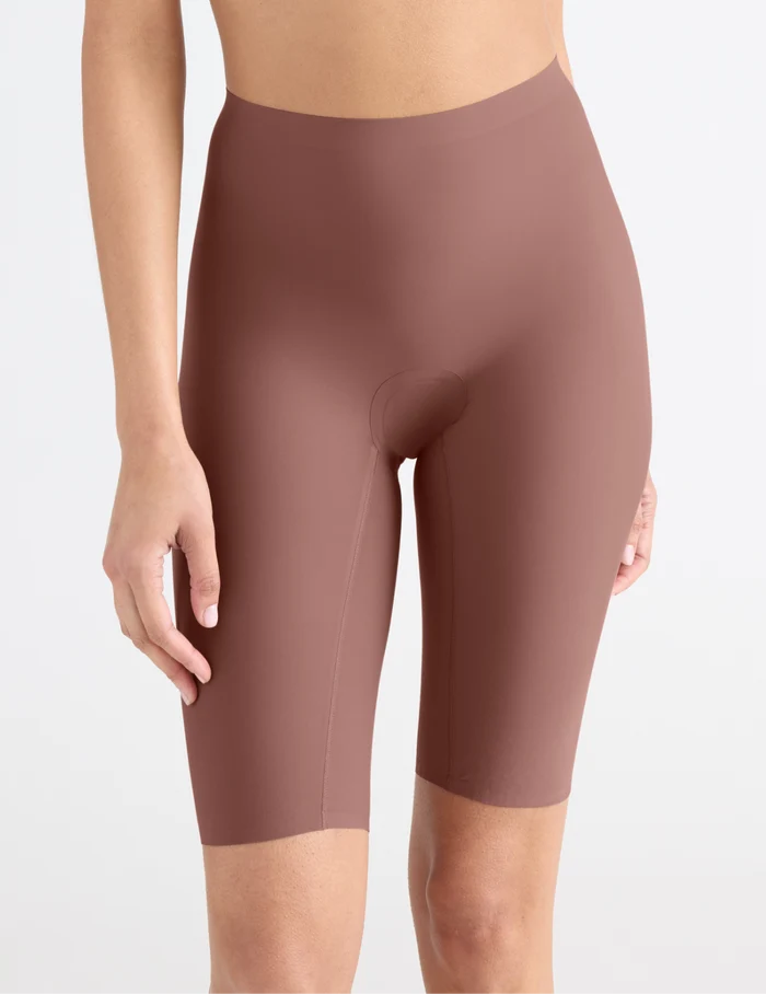 | Front view of model wearing the Leakproof Thigh Saver® 10”, highlighting the coverage and smooth fit | Sola