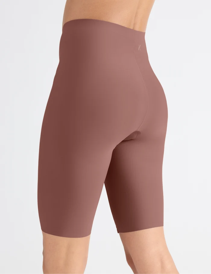 | Side view of model wearing the Leakproof Thigh Saver® 10”, highlighting the coverage and smooth fit | Sola