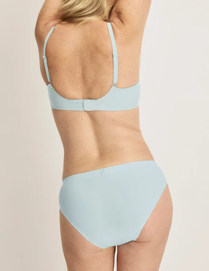 | Front view of model wearing the Light Leakproof No-Show Bikini 3-Pack highlighting the coverage and smooth fit | Twilight Navy/Blue Light/White