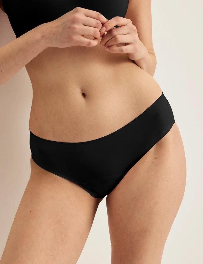| Front view of model wearing the Light Leakproof No-Show Bikini highlighting the coverage and smooth fit | Black
