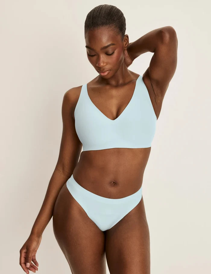 | Front view of model wearing the Light Leakproof No-Show Thong 3-Pack highlighting the coverage and smooth fit | Twilight Navy/Blue Light/White