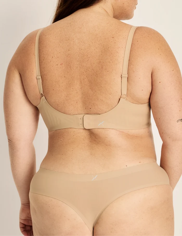 Clementine has 51” hips, and wearing KNIX XXL | Back view of model wearing the Light Leakproof No-Show Thong highlighting the coverage and smooth fit | Warm Sand