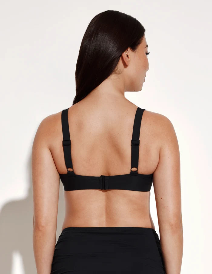 | Back view of model wearing the Limited-Edition Sculpt Ruched Bikini Top, highlighting the neckline, strap design, and silhouette | Black