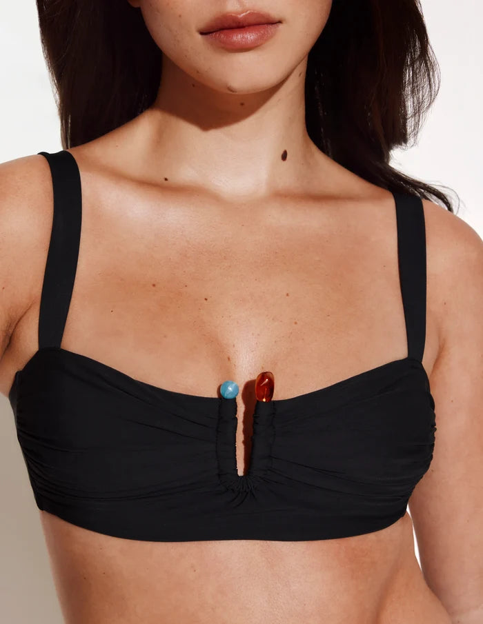 | Front view of model wearing the Limited-Edition Sculpt Ruched Bikini Top, highlighting the neckline, strap design, and silhouette | Black