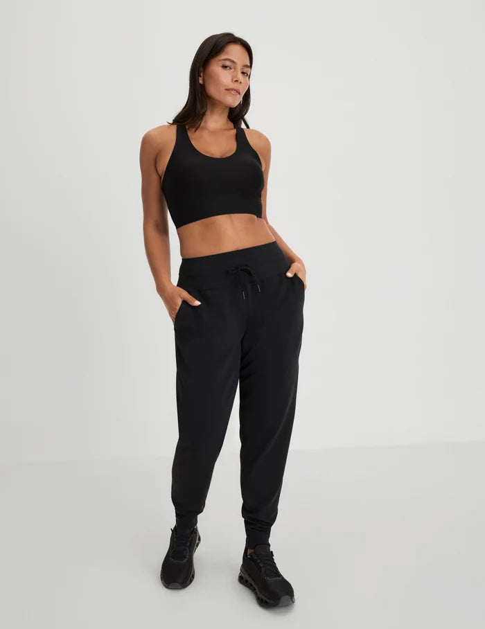 | Full-body view of model wearing the Longevity Sports Bra, highlighting the neckline, strap design, and silhouette | Black