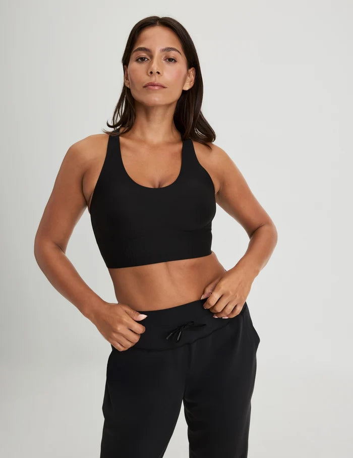 | Front view of model wearing the Longevity Sports Bra, highlighting the neckline, strap design, and silhouette | Black