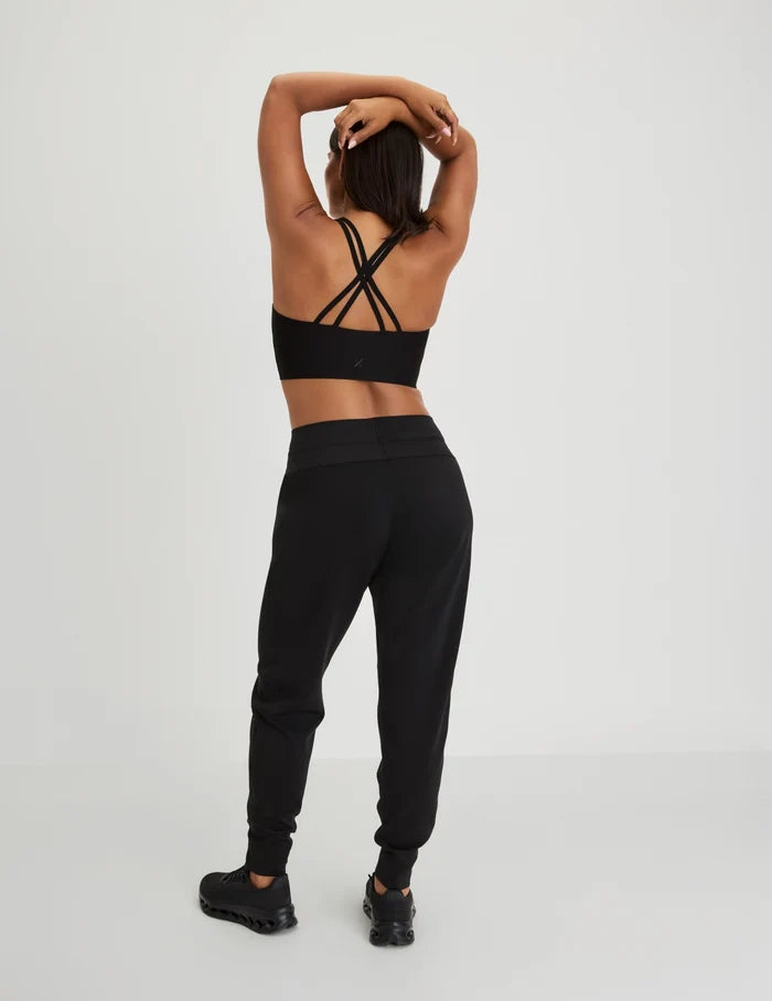 | Back view of model wearing the Longevity Sports Bra, highlighting the neckline, strap design, and silhouette | Black