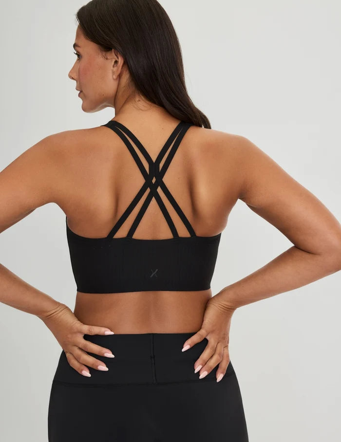 | Back view of model wearing the Longevity Sports Bra, highlighting the neckline, strap design, and silhouette | Black