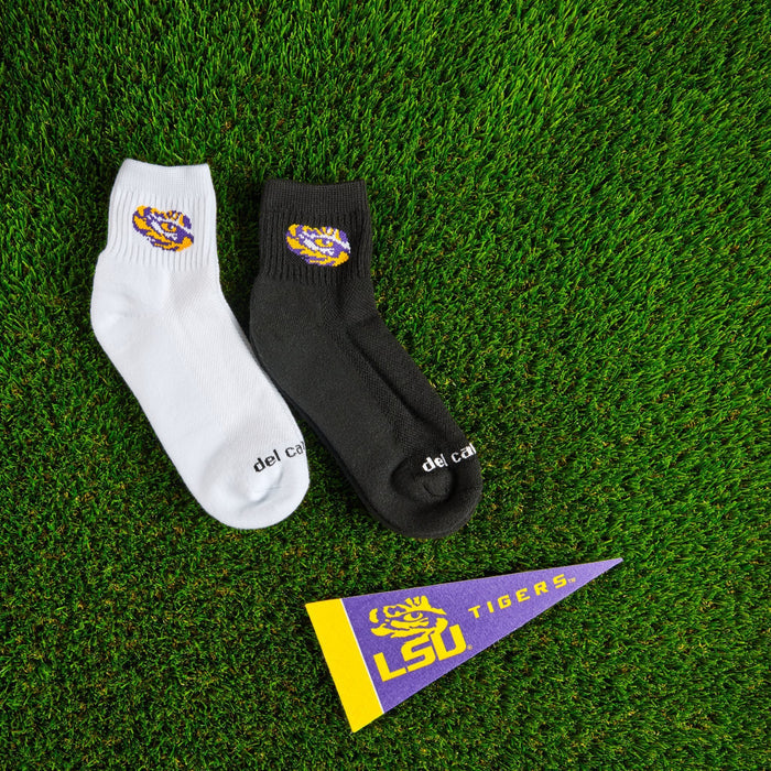 Del Campo LSU Tigers golf socks on turf, white sock beside the black Night Mode