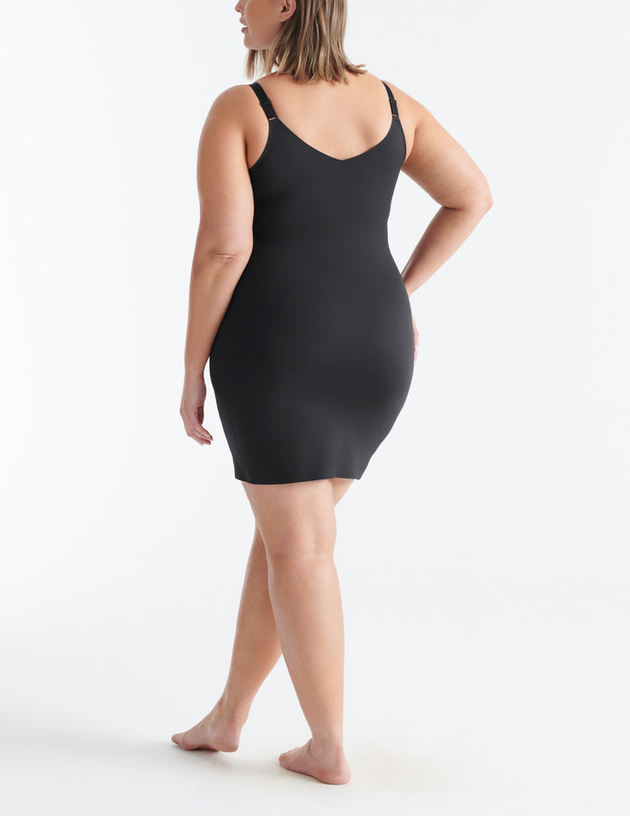 Gabrielle is a 38DD and has 45" hips and wears a Knix size XL | Back view of model wearing the LuxeLift Slip highlighting the neckline, strap design and fit | Black