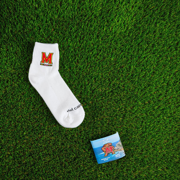Flat lay of Del Campo Maryland Terrapins golf socks with game-day props