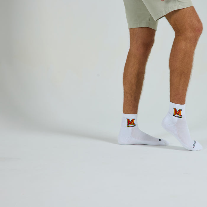 Man wearing Del Campo Maryland Terrapins golf socks, studio shot, no shoes