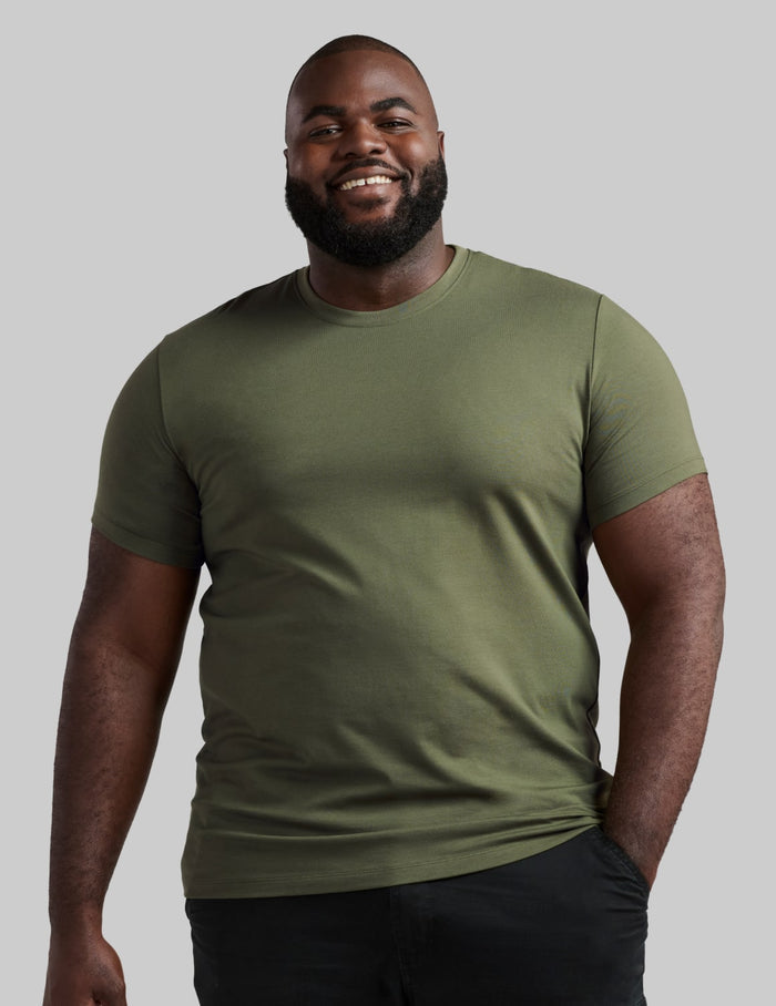 | Front view of model wearing the Men's Best Damn Tee highlighting the coverage and fit | Moss