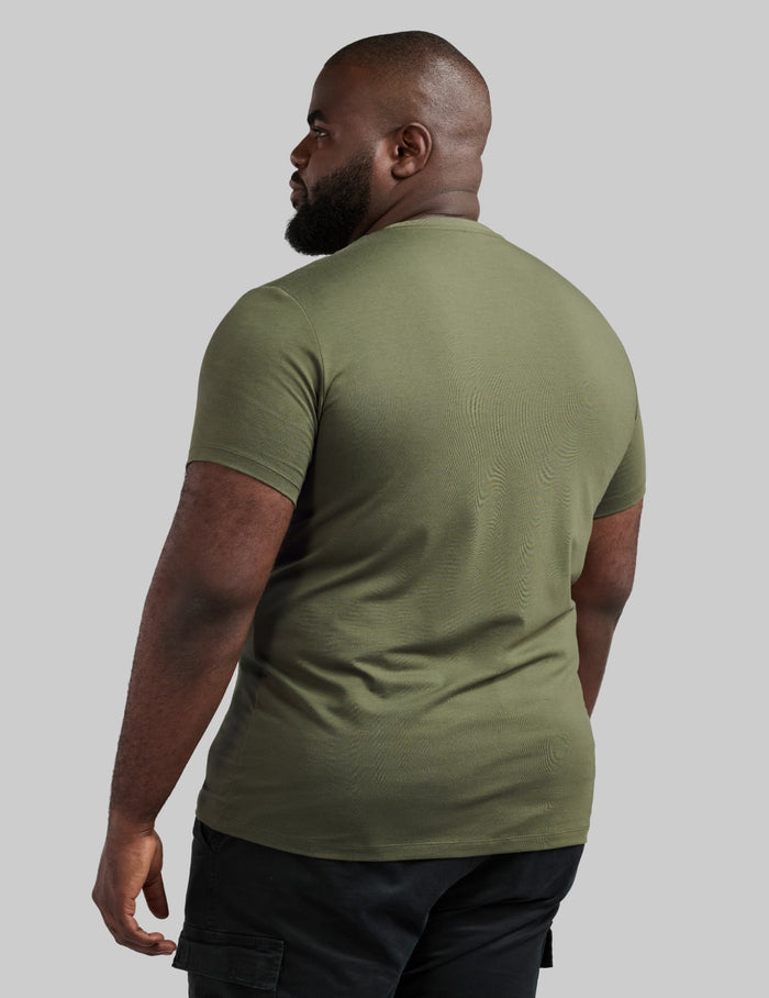 | Back view of model wearing the Men's Best Damn Tee highlighting the coverage and fit | Moss