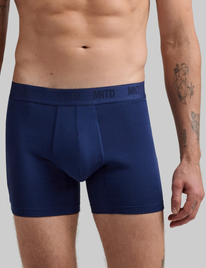 | Front view of model wearing the Men's Buffer Cotton Boxer Brief 5" highlighting the coverage and fit | Midnight