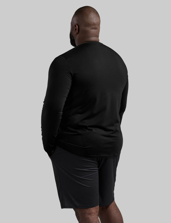| Back view of model wearing the Men's CoolShift™ Long Sleeve highlighting the coverage and fit | Black