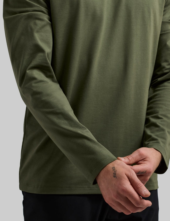 | Front view of model wearing the Men's Relaxed Fit Best Damn Long Sleeve highlighting the coverage and fit | Moss