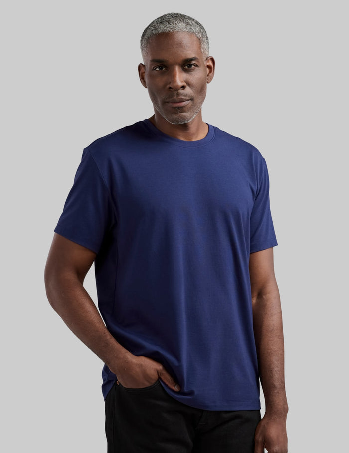 | Front view of model wearing the Men's Relaxed Fit Best Damn Tee highlighting the coverage and fit | Midnight