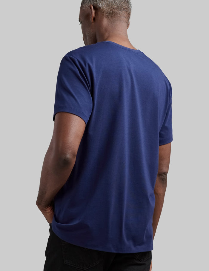 | Back view of model wearing the Men's Relaxed Fit Best Damn Tee highlighting the coverage and fit | Midnight