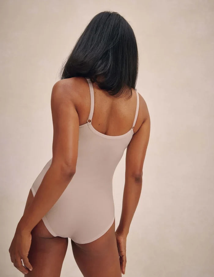 | Back view of model wearing the Mesh Deep V Bodysuit, highlighting the neckline, strap design, and silhouette | Oyster