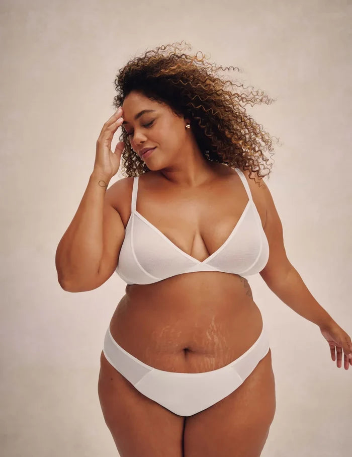 | Full-body view of model wearing the Mesh Deep V Bra, highlighting the neckline, strap design, and smooth silhouette | White