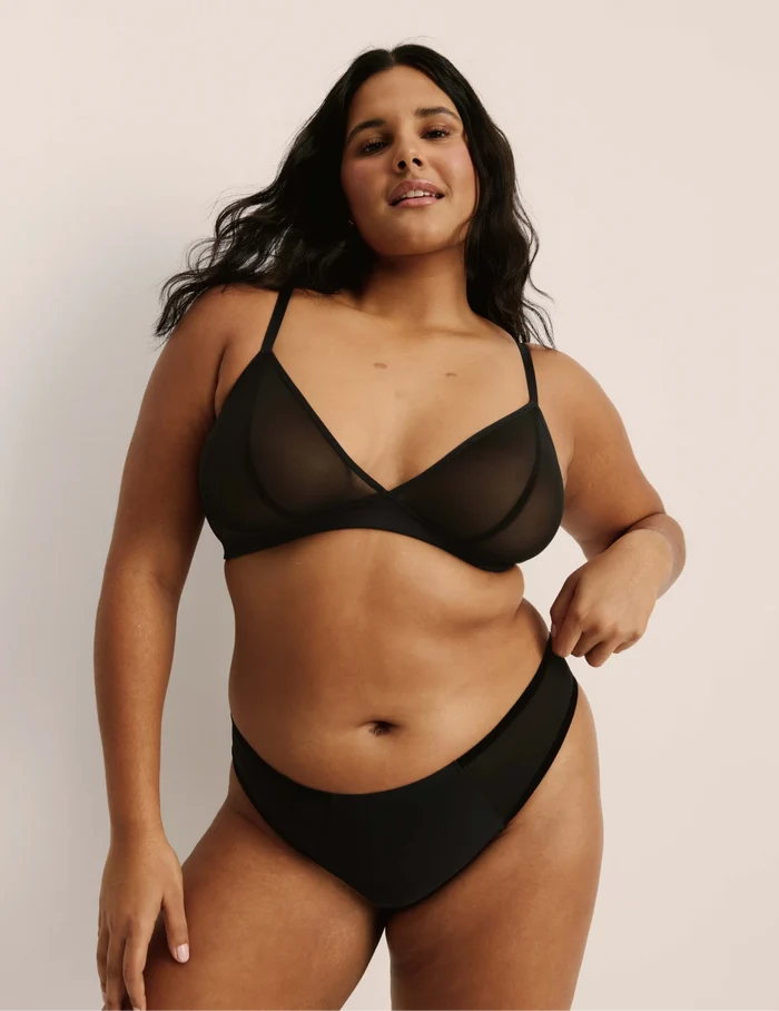 Adiya is a 36C and wearing KNIX L  | Full-body view of model wearing the Mesh Deep V Bra, highlighting the neckline, strap design, and smooth silhouette | Black