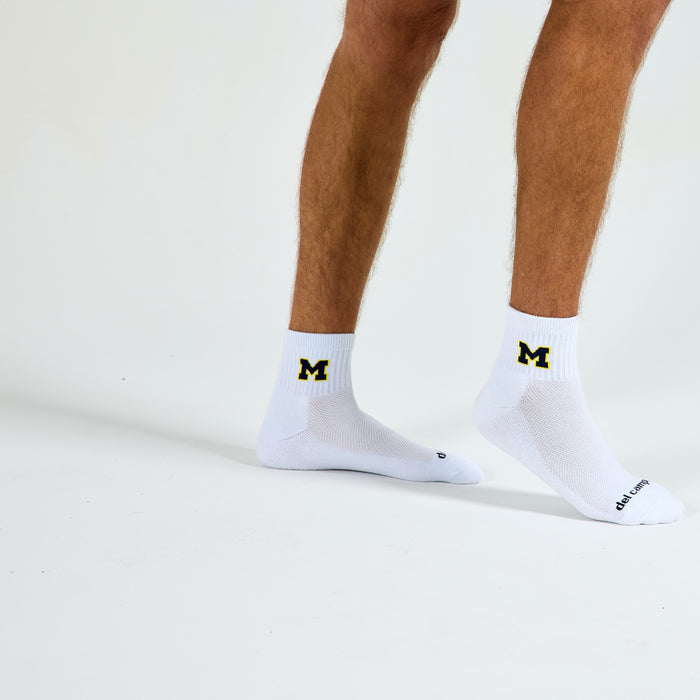 Del Campo Michigan Maize golf socks on a male model in studio