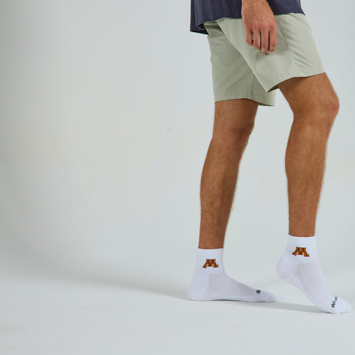 Man wearing Del Campo Minnesota Golden Gophers golf socks, studio shot, no shoes