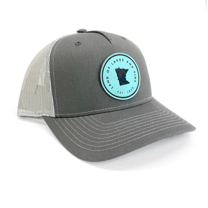 Gray and white cap with a teal and black "Land of Lakes and PIne" logo.