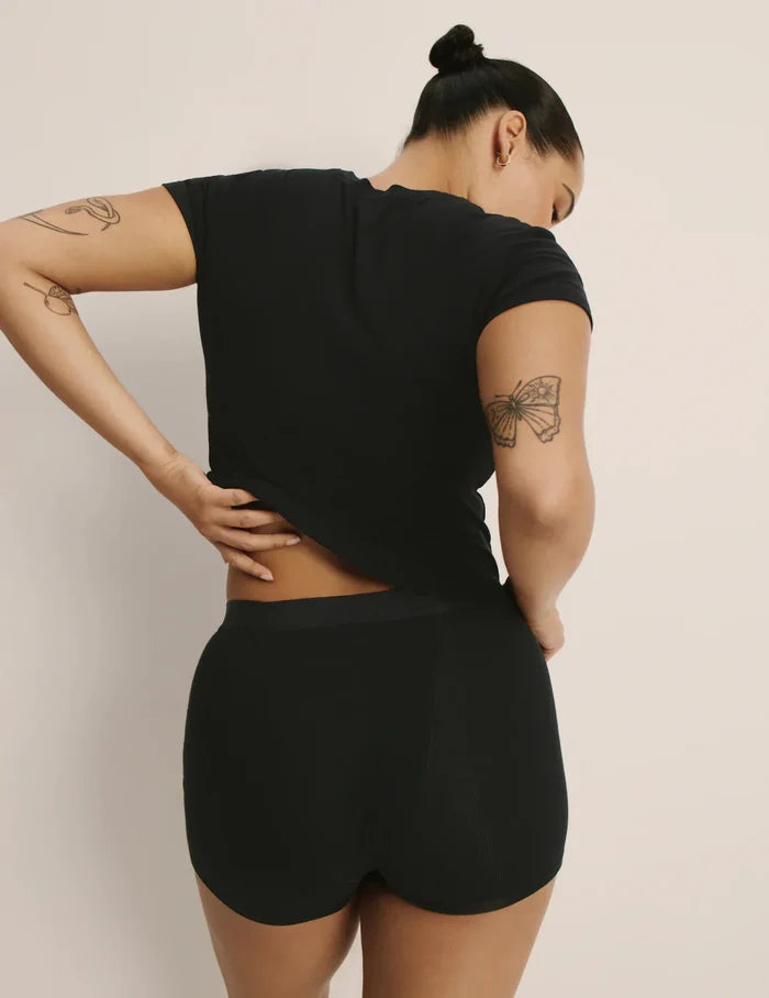Andie is a 34E and is wearing a Knix size M | Back view of model wearing the Modal Rib T-Shirt highlighting the coverage and fit | Black