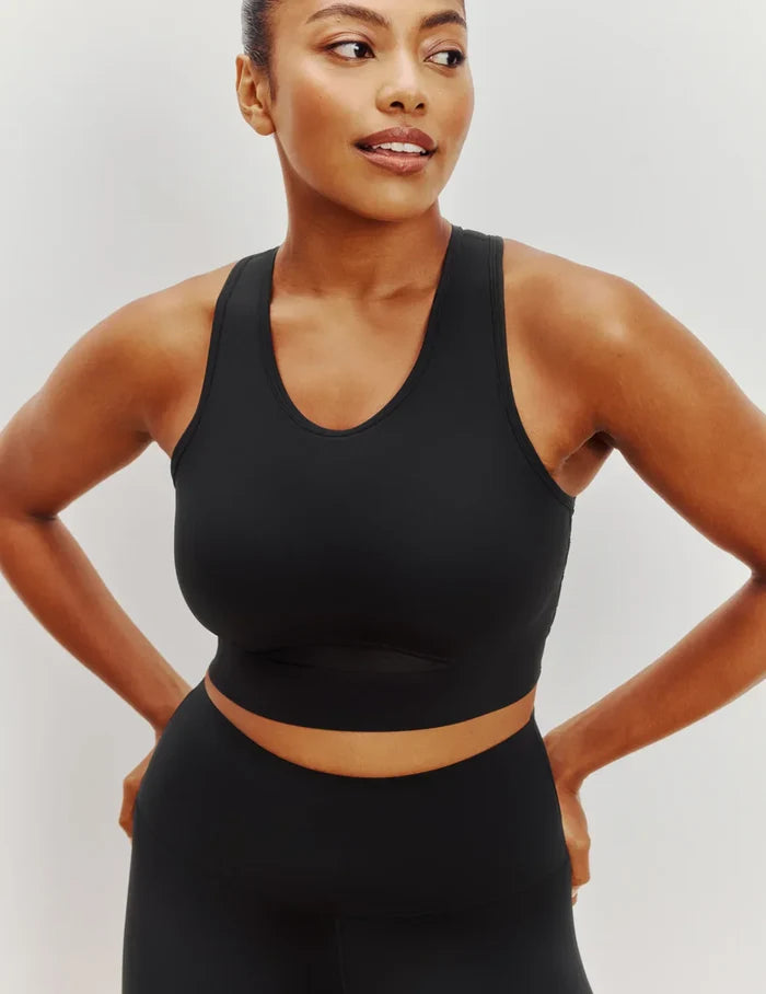 Cassaerea is a 34G and wears a Knix size M++ | Front view of model wearing the Momenta Racerback Sports Bra, highlighting the neckline, strap design, and silhouette | Black