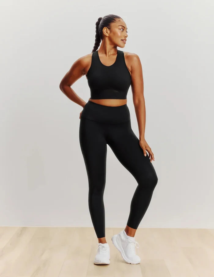 Cassaerea is a 34G and wears a Knix size M++ | Full-body view of model wearing the Momenta Racerback Sports Bra, highlighting the neckline, strap design, and silhouette | Black