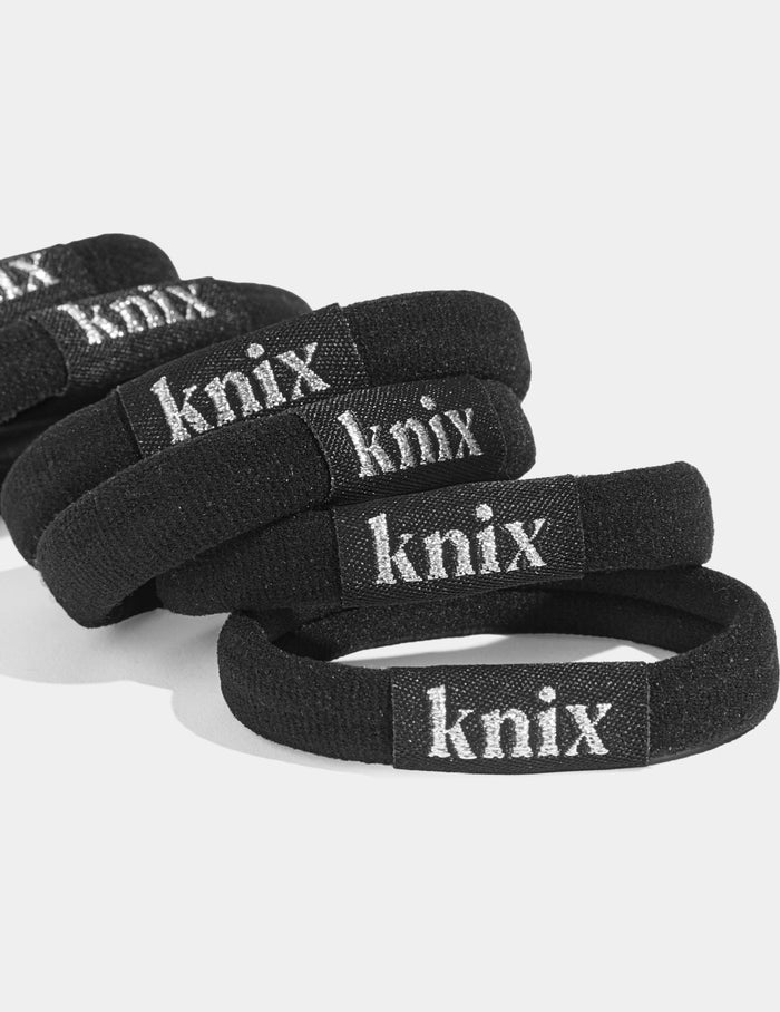| Close-up of Knix Logo on the No-Slip Hair Ties 6-Pack shown front-facing against a light gray background | Black
