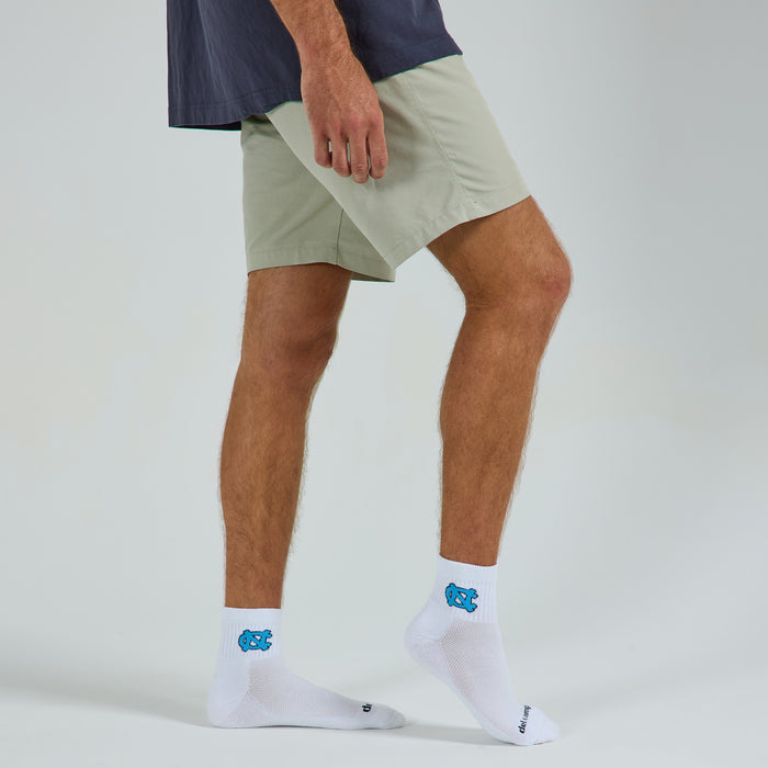 Man wearing Del Campo North Carolina Interlocking NC golf socks, studio shot, no shoes
