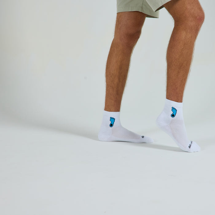 Man wearing Del Campo North Carolina Tar Heel golf socks, studio shot, no shoes