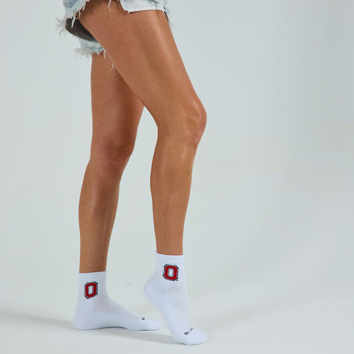 Woman wearing Del Campo Ohio State Buckeyes golf socks, studio shot, no shoes