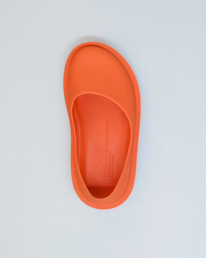 Orange rubber slipper with oval footbed and raised heel cup, viewed from above.