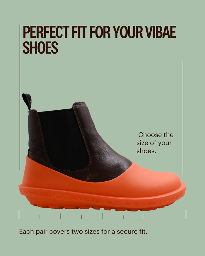 Orange and brown rubber shoe cover with elastic side panels and textured sole.